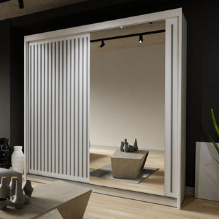 The Sliding Wardrobe - ZEUS 2 Door Mirrored Wardrobe White 150cm features mirrored doors and a sleek striped design, shown in a minimalist room with wooden floors, neutral walls, a coffee table, and decorative vases.