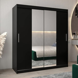 The Tavira I Mirrored Wardrobe with 2 sliding doors (180cm, black) stands in a modern bedroom, reflecting the bed and minimalist decor in its sleek finish.