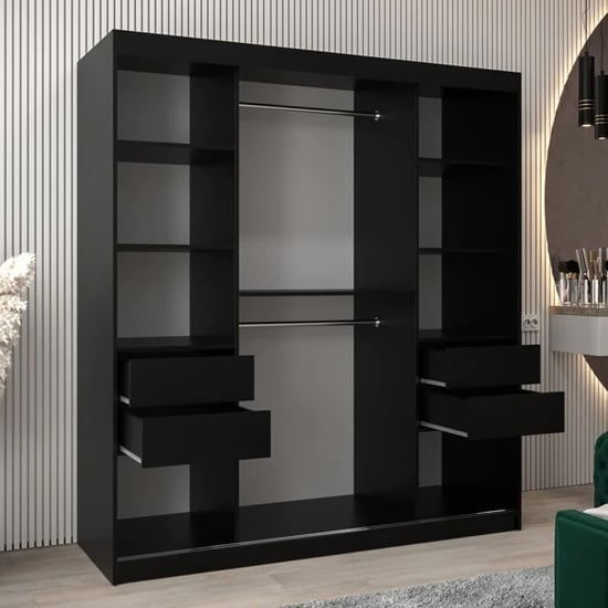 Black sliding wardrobe, Tavira I, with mirrored doors, two drawers open, internal shelves and hanging rails.
