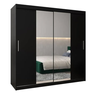 The Tavira I Mirrored Wardrobe 2 Sliding Doors 200cm in Black reflects a modern bedroom with a green bed, striped wall panel, and rug.