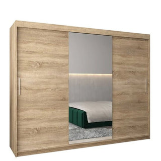 The Tavira I Mirrored Wardrobe (250cm) features three sliding doors—two in Sonoma Oak and one full-length mirror—set against a white background, reflecting a stylish modern bedroom.