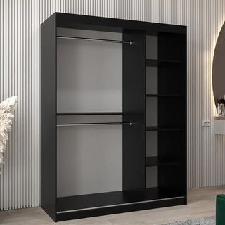 The Tavira II Mirrored Wardrobe (2 Sliding Doors, 150cm, Black) stands against a striped wall, featuring two left-side hanging rods and four right-side shelves. A round mirror and decor enhance this stylish wardrobe setup.