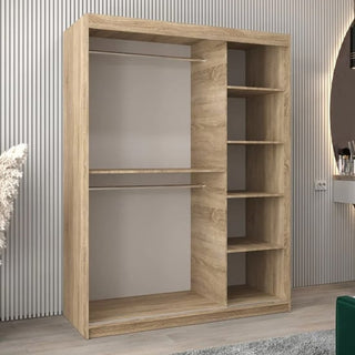 The Tavira II Mirrored Wardrobe 2 Sliding Doors 150cm in Sonoma Oak has two open sections: the left with hanging rods for clothes, the right with five storage shelves. It complements a modern, minimally decorated room.