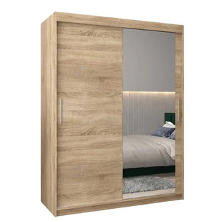 The Tavira II Mirrored Wardrobe features 2 sliding doors, including a full-length mirror. Finished in light Sonoma Oak with metallic handles, it adds modern elegance and enhances your bedroom's style. Width: 150cm.