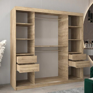The Tavira II Mirrored Wardrobe with 2 sliding doors in Sonoma Oak, featuring open shelves, two hanging rods, and four extended drawers, stands empty against a vertically lined wall in a modern room.