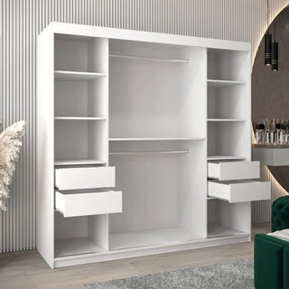 The Tavira II Mirrored Wardrobe with 2 sliding doors (200cm, White) features multiple shelves, two hanging rods, and four drawers—two left partially open—and stands in a modern room with a striped wall and contemporary décor for added style and function.