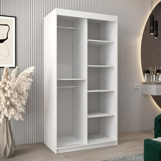 The Tavira III Mirrored Wardrobe in white (100cm) features two sliding doors, two hanging rods on one side, and five shelves on the other—combining style and function for a modern bedroom.