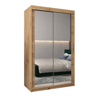 The Tavira III Mirrored Wardrobe features two 120cm sliding mirrored doors, metal handles, and an artisan oak finish for a modern look.