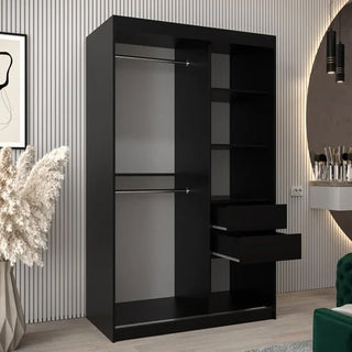 The Tavira III Mirrored Wardrobe in black (120cm, 2 sliding doors) features two hanging rods, multiple open shelves, and two partially open drawers, and stands against a vertically-lined wall in a contemporary room.