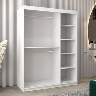 The Tavira III Mirrored Wardrobe with 2 sliding doors (150cm, white) features two open hanging sections on the left and five shelves on the right, adding style to a modern room with a striped wall and round mirror.