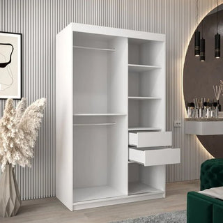 The Tavira Wooden Wardrobe 2 Sliding Doors 120cm in White, featuring two open hanging sections, four shelves, and two drawers, stands in a modern room with striped walls, a round mirror, makeup table, green chair, and pampas grass.
