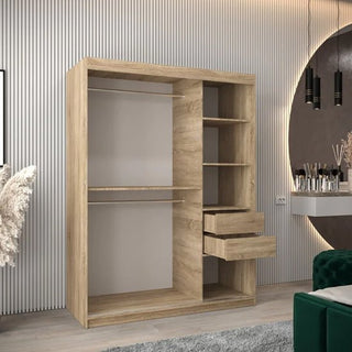 The Tavira Wooden Wardrobe 2 Sliding Doors 150cm in Sonoma Oak features two hanging sections, four shelves, and two partially open drawers, shown in a modern room with striped walls, plants, a vanity, and pendant lights.