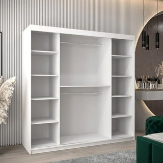 A Tavira Wooden Wardrobe 2 Sliding Doors 200cm in White stands in a modern room with striped walls, a vanity table, and decorative items. It features two central hanging rods and multiple shelves on both sides.
