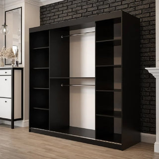 The Topeka 2 Mirrored 200cm Wardrobe with sliding doors in dark oak is placed on a wood floor in a modern room with a black brick accent wall and white trim.