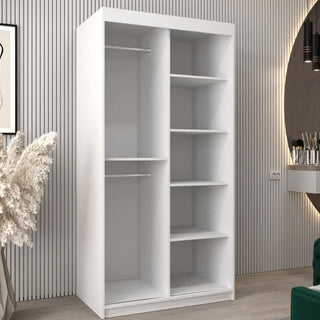 The Vevey I Wooden Wardrobe with 2 sliding doors in white (100cm) features two left hanging rods and five right shelves, showcased in a modern room with vertical panel walls and decorative accents.