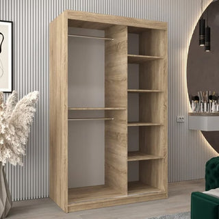The Vevey I Wooden Wardrobe 2 Sliding Doors 120cm in Sonoma Oak features two hanging rods and five shelves, offering an open, modern design that complements rooms with vertical wall panels and decorative elements.