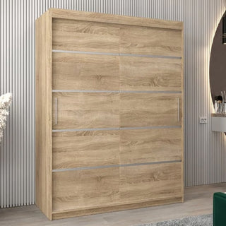 The Vevey I Wooden Wardrobe with 2 sliding doors in Sonoma Oak (150cm) and four horizontal metallic strips is featured in a modern room with textured wall panels.