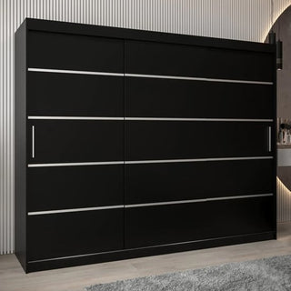 The Vevey I Wooden Wardrobe 3 Sliding Doors 250cm in Black is a spacious wardrobe with sliding doors and silver handles, displayed on a light wood floor against vertical white paneling, with part of a gray rug visible.