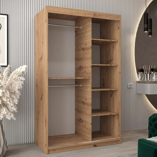 The Vevey II Mirrored Wardrobe with 2 sliding doors in Artisan Oak (120cm) features two left-side hanging rods and five right-side shelves of varying sizes, displayed in a modern room with striped walls and decor.