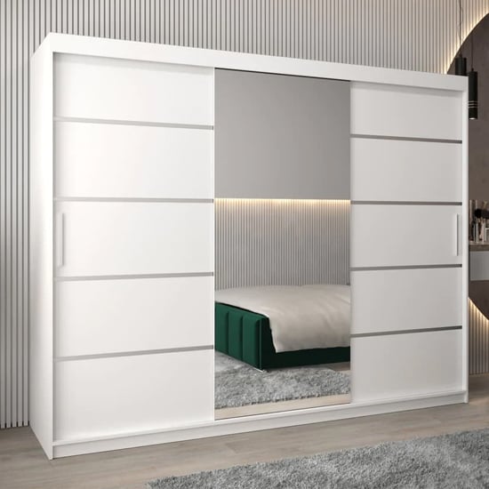 White 250cm 3-door sliding wardrobe with a mirrored door panel, shown in a modern bedroom with vertical wall panelling.