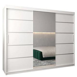 The Vevey II Mirrored Wardrobe 3 Sliding Doors 250cm in White features a large center mirror that reflects a modern bedroom with a green bed, gray carpet, and a headboard with vertical grooves and lighting.