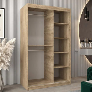 The Vevey III Mirrored Wardrobe with 2 sliding doors (120cm, Sonoma Oak) features two left hanging rails and five right open shelves, shown in a modern room with striped walls, decorative plants, and a vanity table.