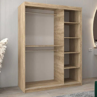 The Vevey III Mirrored Wardrobe (150cm, Sonoma Oak) features 2 sliding doors, with two hanging rods on the left and five open shelves on the right, ideal for a modern room with a striped wall and round mirror.