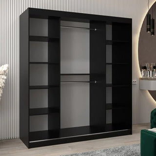 The Vevey III Mirrored Wardrobe with 2 sliding doors (180cm, black) features central hanging rods and side shelves, perfectly suited for a modern room with striped wall paneling and contemporary decor.