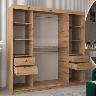 The Vevey III Mirrored Wardrobe (200cm, Artisan Oak) with 2 sliding doors features multiple shelves, drawers on each side—some open—and two hanging rods, standing against a striped wall in a modern room.