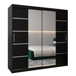 The Vevey III Mirrored Wardrobe 2 Sliding Doors 200cm in Black reflects a modern bedroom with a green bed, gray rug, and an accent wall featuring vertical lines and LED lighting.