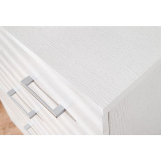 CHOICEWARDROBE PRADA white chest of drawers close-up with silver handles and wood grain texture