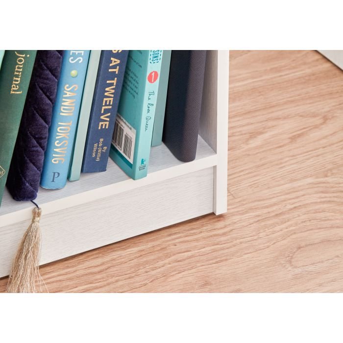 White 3 door wardrobe with visible tassel detail and books on shelf including 'Sandi Toksvig' and 'Sat Twelve'.