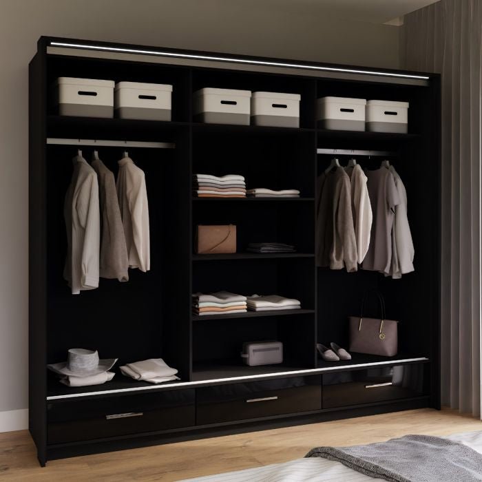 Black high gloss 3-door sliding wardrobe with LED lighting, showing shelves and hanging rails.