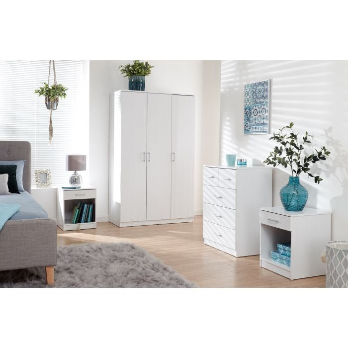 White 3-door wardrobe with matching chest of drawers and 2 bedside tables in a bedroom