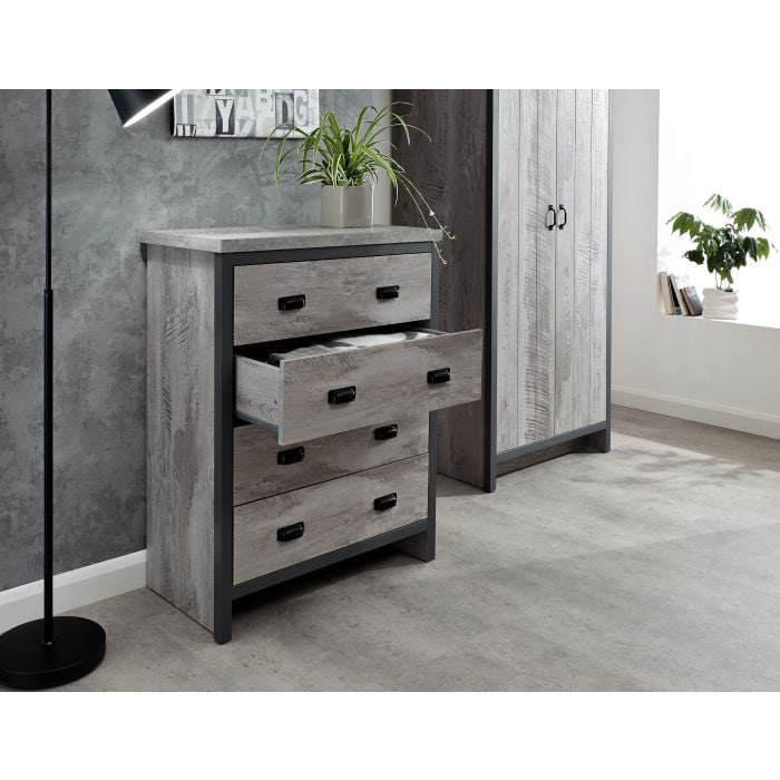 Grey distressed wood-effect chest of drawers with four drawers, one open, black handles.