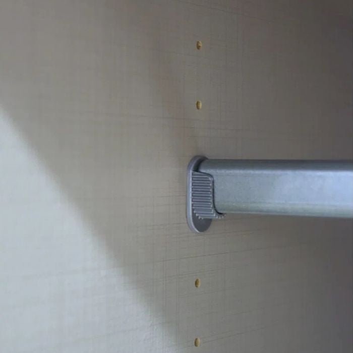 NOMASA 4 Door Wardrobe: hanging rail bracket with visible unused pre-drilled holes on side panel.