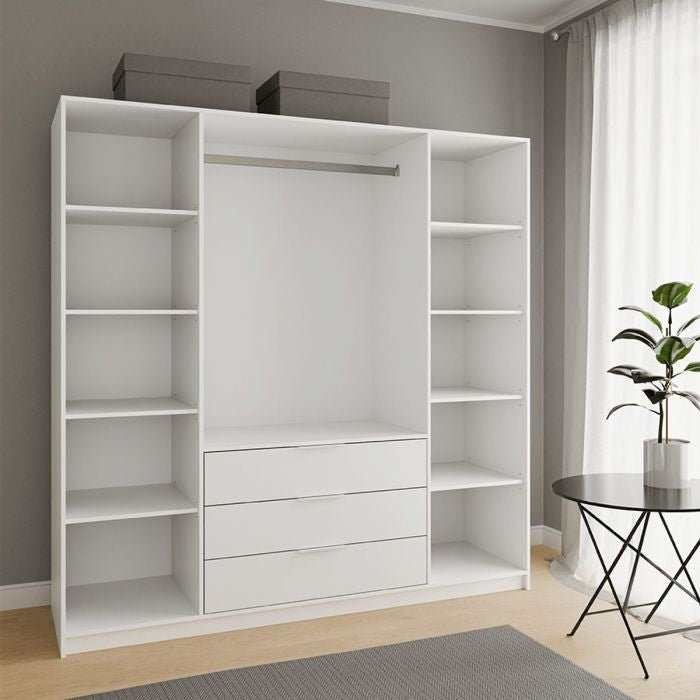 White wardrobe interior with shelves on the sides and three drawers in the centre.