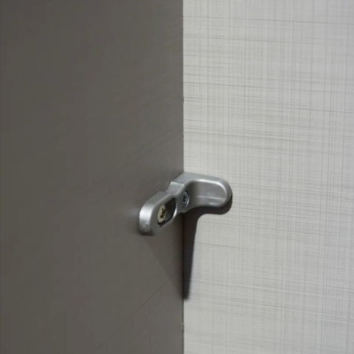 Metal handle on grey and textured panel corner of NOMASA wardrobe
