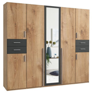 The FENTON 5 Door Wardrobe in oak and graphite (225cm) features black drawers with silver handles and a tall mirrored door, adding style and reflecting home decor in your room.