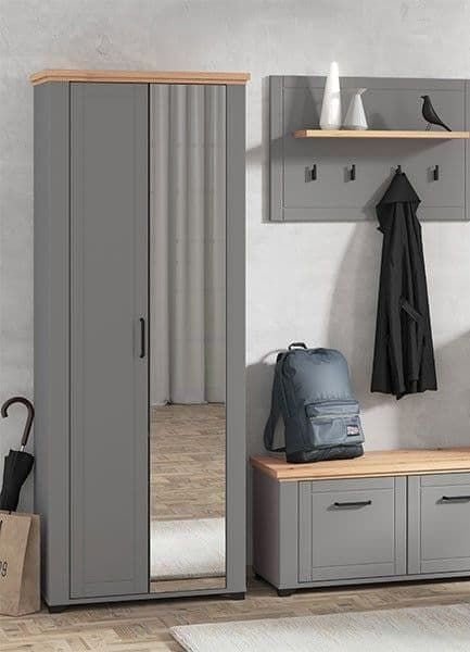 HESTA 75cm grey and artisan oak wardrobe with mirrored doors, beside a storage bench with a backpack.