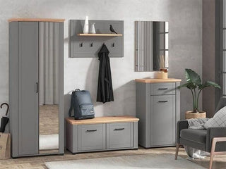 A modern entryway features the HESTA 2 Door Mirrored Wardrobe in Grey and Artisan Oak (75cm), gray cabinets with wood tops, a storage bench, wall mirror, coat rack with hooks, blue backpack, decorative items, and a green potted plant near an armchair.